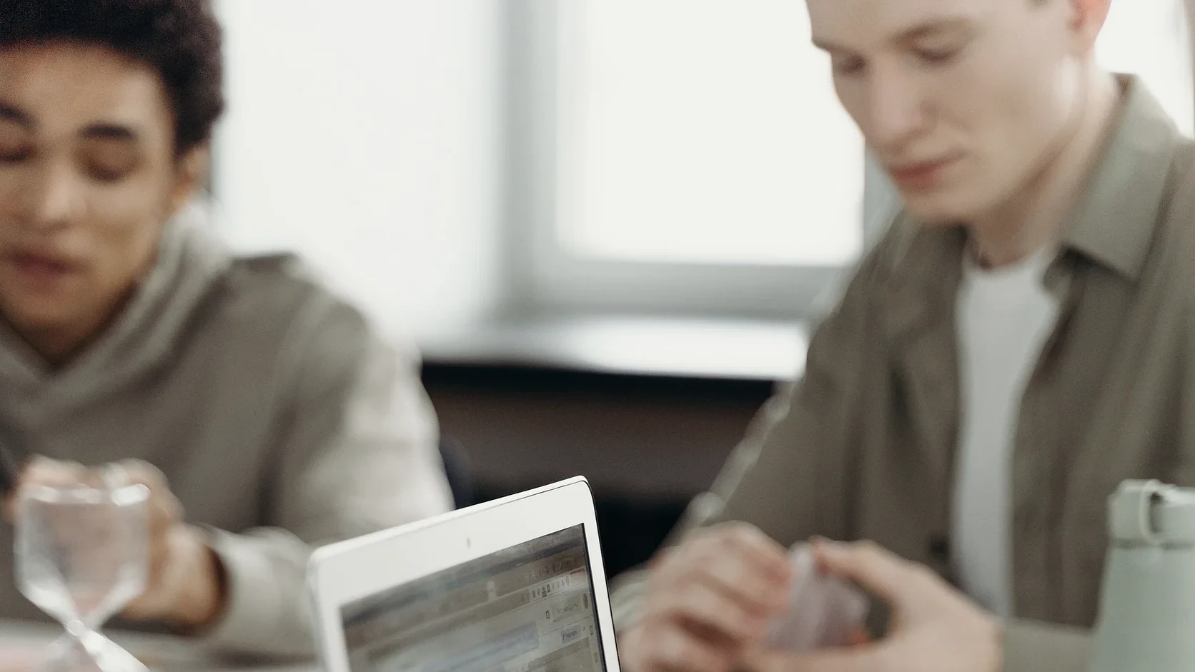 Finance team reviewing receivables together around a laptop