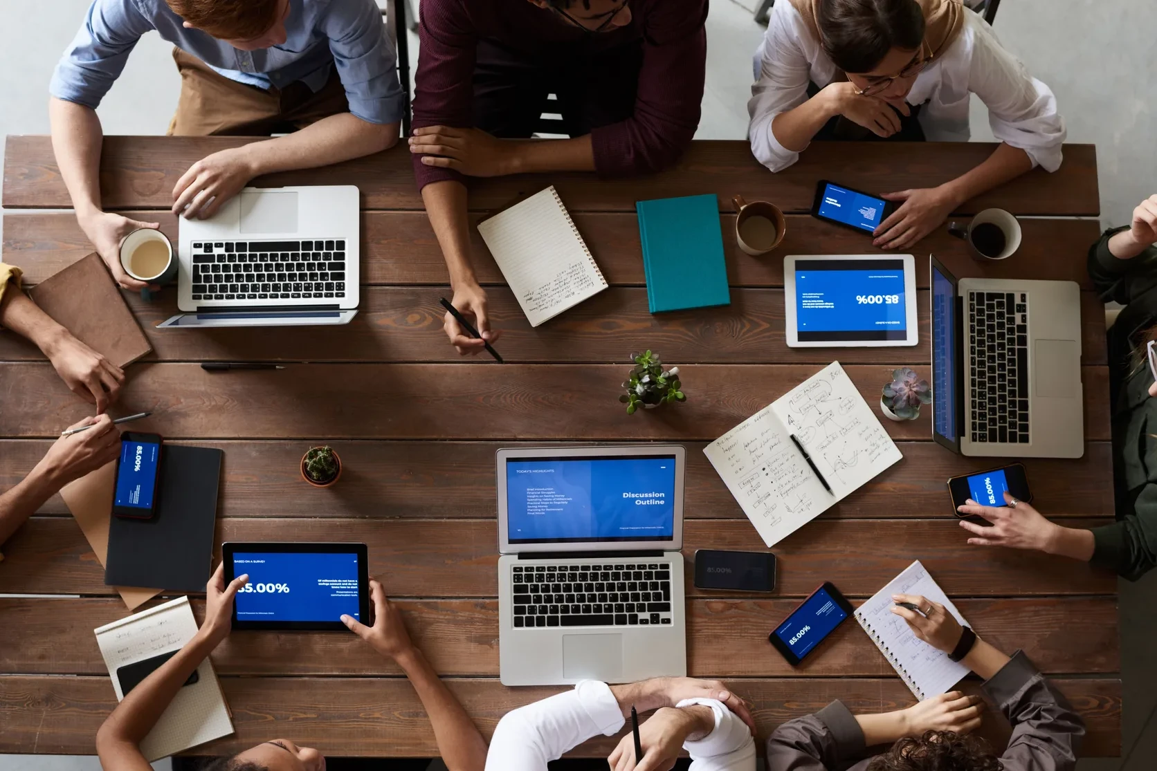 Product and finance team discussing data, workflows, and platform strategy around a laptop