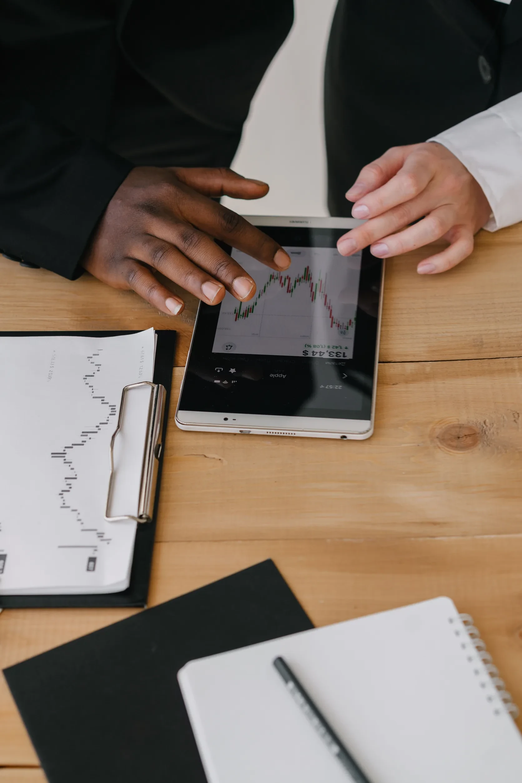 Business professionals reviewing financial charts on a tablet